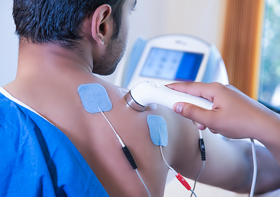 Medical professional administering electrotherapy treatment