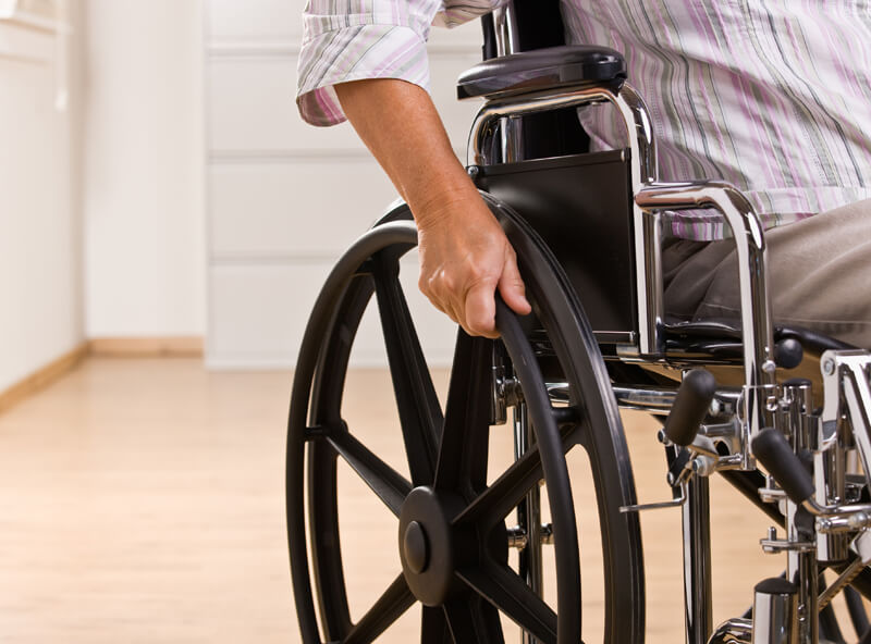 Healthcare professional assisting patient with walking aids