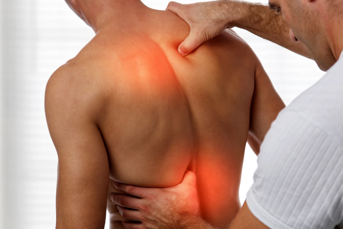 Physical therapist assisting patient during rehabilitation